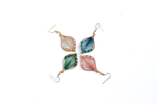 Thread and bead teardrop earrings in rose, champagne, emerald, and peacock blue. Made with hypoallergenic hooks. 