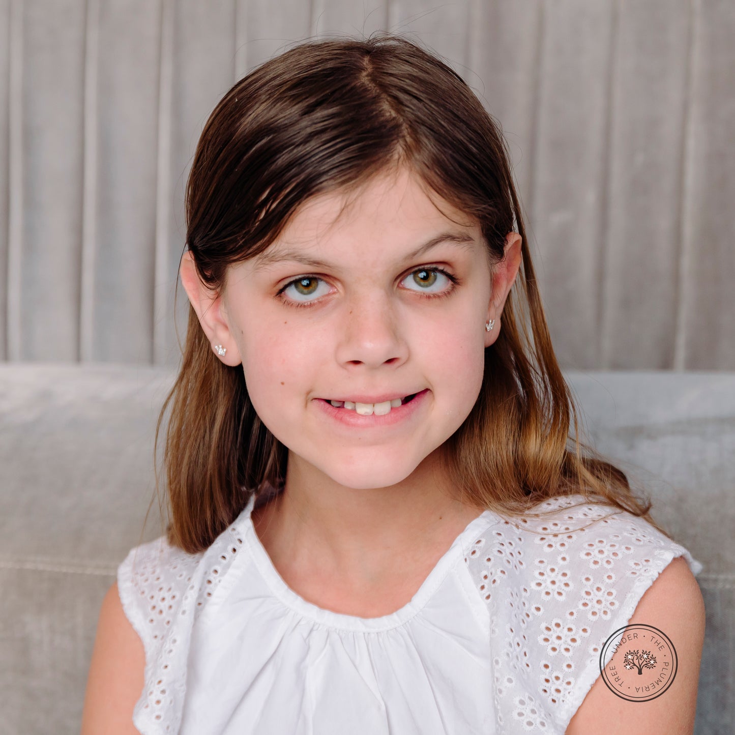 Girl modeling silver white sparkly crown earrings for the Royal Coronation.